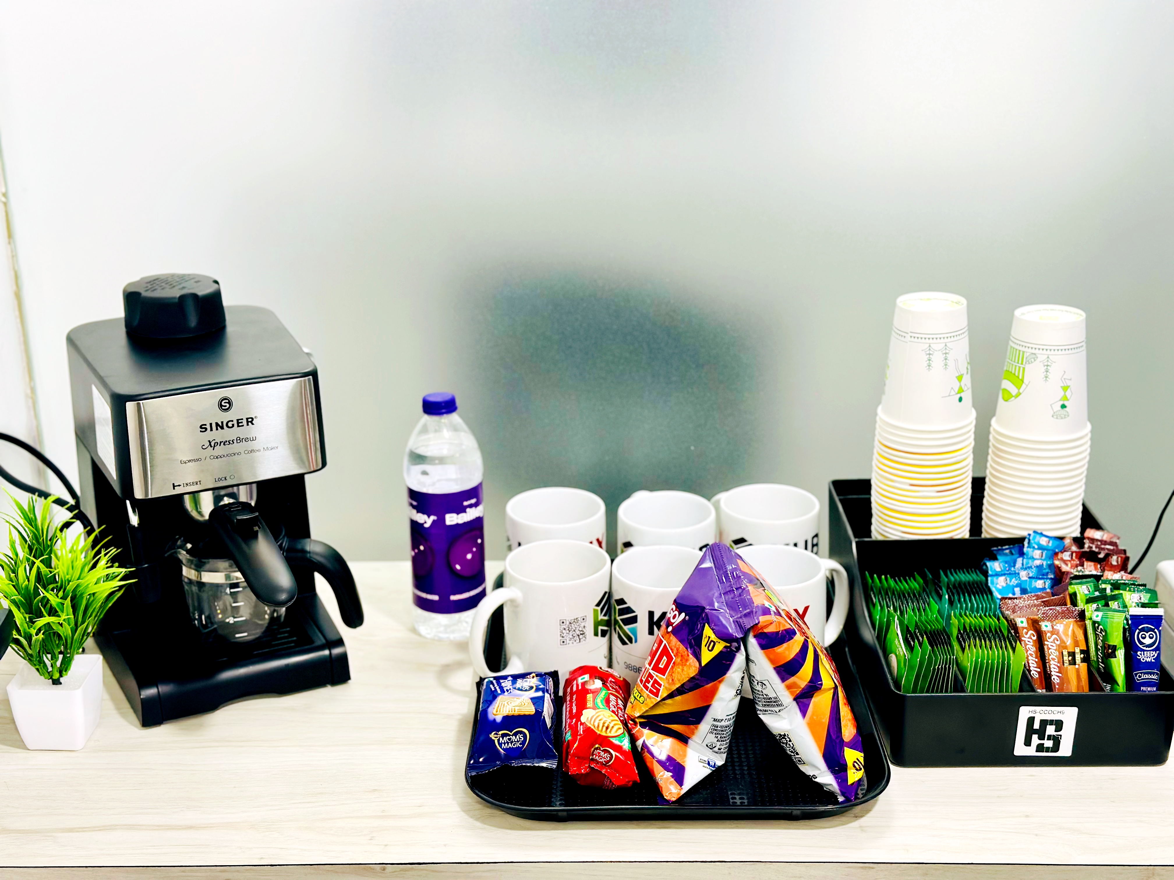 Coffee machine, tea station, water dispenser, and curated snack area